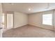 Spacious bedroom with neutral carpet, a large window, and two entryways at 513 Moline Way, Locust Grove, GA 30248