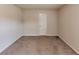 Modest bedroom with neutral colored walls and carpet, plus a white door at 513 Moline Way, Locust Grove, GA 30248