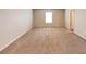 Large bedroom with neutral color walls and carpet, bright window and white trim at 513 Moline Way, Locust Grove, GA 30248