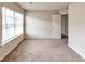 Well lit bedroom showcasing a large window, neutral color walls and carpet at 513 Moline Way, Locust Grove, GA 30248