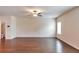 Expansive living room boasts gleaming hardwood floors, neutral paint, and abundant space for living at 513 Moline Way, Locust Grove, GA 30248