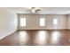 Bright and spacious living room featuring hardwood floors, large windows, and ample natural light at 513 Moline Way, Locust Grove, GA 30248