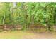 Large backyard surrounded by mature trees and a wooden fence at 847 Ashley Ln, Stone Mountain, GA 30087
