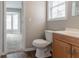 Bright bathroom features wood-look flooring, a white toilet and a single-sink vanity at 847 Ashley Ln, Stone Mountain, GA 30087