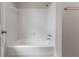 Bathroom featuring a white tile tub and shower combo with silver hardware at 847 Ashley Ln, Stone Mountain, GA 30087