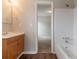 This bathroom offers a white tiled tub/shower combo and a wood-look vanity with white sink at 847 Ashley Ln, Stone Mountain, GA 30087