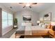 Well lit main bedroom featuring neutral decor, a ceiling fan and a large window at 847 Ashley Ln, Stone Mountain, GA 30087