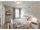 Bright and cozy bedroom featuring art, shelves, modern bed and nightstand at 847 Ashley Ln, Stone Mountain, GA 30087