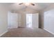 Large bedroom features neutral carpet, a ceiling fan, a closet and grey painted walls at 847 Ashley Ln, Stone Mountain, GA 30087