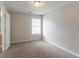Clean and bright carpeted bedroom with a window providing natural light at 847 Ashley Ln, Stone Mountain, GA 30087