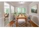 Elegant dining room with wood table, upholstered chairs, stylish rug, and natural light at 847 Ashley Ln, Stone Mountain, GA 30087