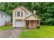 Charming two-story home with a bay window, covered porch, attached garage and lush lawn at 847 Ashley Ln, Stone Mountain, GA 30087