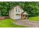 Charming two-story home with a bay window, covered porch, attached garage and lush lawn at 847 Ashley Ln, Stone Mountain, GA 30087