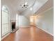 Open living room featuring a fireplace, high ceilings, arched windows, and hardwood floors at 847 Ashley Ln, Stone Mountain, GA 30087