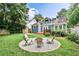 Expansive backyard features mature trees, blue home, and fire pit with seating at 1136 Moreland Se Pl, Atlanta, GA 30316