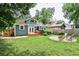Spacious backyard features a blue house, a deck, and a fire pit area at 1136 Moreland Se Pl, Atlanta, GA 30316