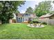 Well-maintained backyard with lush lawn, blue home, and a fire pit for entertaining at 1136 Moreland Se Pl, Atlanta, GA 30316