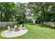Lush backyard with mature trees, fire pit, and plenty of open space at 1136 Moreland Se Pl, Atlanta, GA 30316