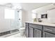 Bright bathroom features a glass shower with modern tiling and gray vanity at 1136 Moreland Se Pl, Atlanta, GA 30316