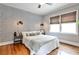Charming bedroom boasts a large bed, stylish wallpaper, and plenty of natural light at 1136 Moreland Se Pl, Atlanta, GA 30316
