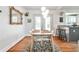 Bright dining area with hardwood floors, a modern light fixture, and a door leading to the backyard at 1136 Moreland Se Pl, Atlanta, GA 30316