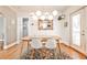 Bright and sunny dining room featuring a modern light fixture, hardwood floors, and a glass door at 1136 Moreland Se Pl, Atlanta, GA 30316