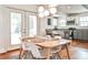 Sunlit dining area with modern lighting and adjacent kitchen, perfect for Gathering meals and entertaining at 1136 Moreland Se Pl, Atlanta, GA 30316