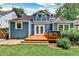 Back exterior view of a charming blue home featuring a wood deck, french doors, and well-maintained landscaping at 1136 Moreland Se Pl, Atlanta, GA 30316