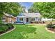 Charming blue cottage home with a cozy front porch and a well-manicured lawn at 1136 Moreland Se Pl, Atlanta, GA 30316