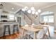 Open-concept kitchen and dining area with breakfast bar, stairs, and table with seating and hardwood floors at 1136 Moreland Se Pl, Atlanta, GA 30316