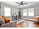 Versatile office space with hardwood floors, three windows, and gray sofa at 1136 Moreland Se Pl, Atlanta, GA 30316
