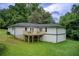 Back of home featuring a deck and lush backyard views with a white exterior and natural colored deck at 1740 Dodson Sw Dr, Atlanta, GA 30311