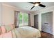 Bright bedroom featuring a window, stylish curtains and gray closet doors at 1740 Dodson Sw Dr, Atlanta, GA 30311