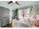 Charming bedroom features unique curtains and grey closet doors at 1740 Dodson Sw Dr, Atlanta, GA 30311