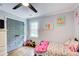 bedroom featuring a hardwood floor, window and grey closet doors at 1740 Dodson Sw Dr, Atlanta, GA 30311