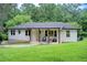 Charming one-story home featuring a painted brick facade and a covered porch with wooden pillars at 1740 Dodson Sw Dr, Atlanta, GA 30311