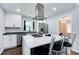 Bright kitchen with white cabinets, stainless appliances, and center island with bar seating at 1740 Dodson Sw Dr, Atlanta, GA 30311