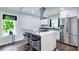 Bright kitchen features white cabinets, stainless steel appliances, and a center island with bar stools at 1740 Dodson Sw Dr, Atlanta, GA 30311