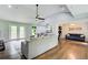 Open living room featuring hardwood floors, access to an outdoor deck, and seamless connectivity to the kitchen and sitting area at 1740 Dodson Sw Dr, Atlanta, GA 30311