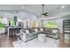 Bright living room showcases a modern design, hardwood floors, and transitions into a kitchen with stainless steel appliances at 1740 Dodson Sw Dr, Atlanta, GA 30311