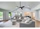 Spacious living room with hardwood floors, neutral paint, vaulted ceiling, and seamless flow into the adjacent kitchen and dining area at 1740 Dodson Sw Dr, Atlanta, GA 30311
