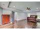 Large primary bedroom featuring hardwood floors, a tray ceiling and an ensuite bathroom adjacent to the bed at 1740 Dodson Sw Dr, Atlanta, GA 30311