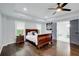 Spacious main bedroom features a tray ceiling, hardwood floors, and an ensuite bathroom with a soaking tub at 1740 Dodson Sw Dr, Atlanta, GA 30311