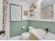 Modern bathroom with green wainscotting and patterned floral shower curtain at 201 Tweed Ct, Sugar Hill, GA 30518