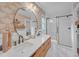 Modern bathroom featuring double sinks, a shower, and bright wallpaper at 201 Tweed Ct, Sugar Hill, GA 30518