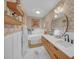 Stylish bathroom with a soaking tub, double sink vanity, and decorative wallpaper at 201 Tweed Ct, Sugar Hill, GA 30518