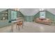 Charming bonus room with natural light, built-in shelves, and whitewashed floors at 201 Tweed Ct, Sugar Hill, GA 30518