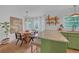 Bright and airy kitchen showcasing an island with barstool seating and stylish green cabinetry at 201 Tweed Ct, Sugar Hill, GA 30518