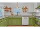 Modern kitchen featuring updated appliances, granite counters, tile backsplash, and green cabinetry at 201 Tweed Ct, Sugar Hill, GA 30518