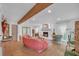 Cozy living room featuring a decorative fireplace, wood beam and an abundance of natural light at 201 Tweed Ct, Sugar Hill, GA 30518